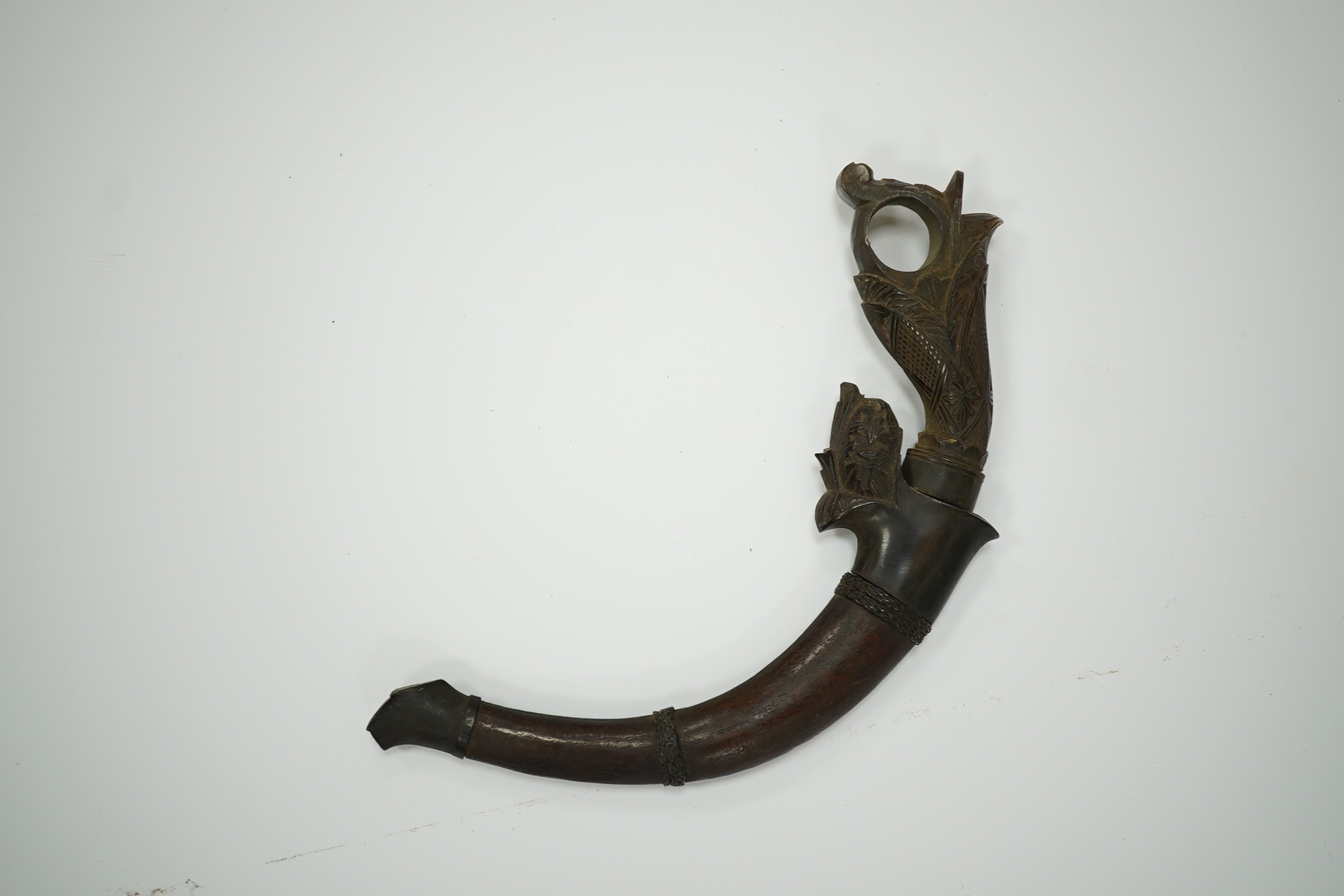 A Korambi sickle dagger in carved wood sheath with horn mounts and horn handle, blade 15cm. Condition - good